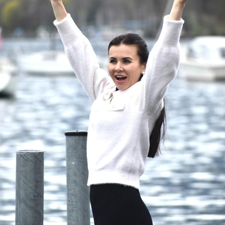 Avery Reed, Lead Design Curator at CalmForwardNetwork, reviewing corporate floral arrangements